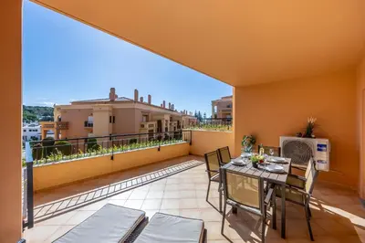 a patio with a table and chairs on a balcony at Sun and Sea - Baia da Luz Apartment in Luz