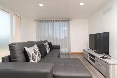 a living room with a couch and a flat screen tv at Casa Terra-Boa in Arco da Calheta