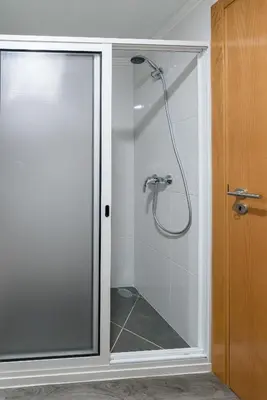 a shower with a glass door in a bathroom at Casa Terra-Boa in Arco da Calheta