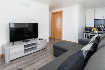 a living room with a couch and a large television at Casa Terra-Boa in Arco da Calheta