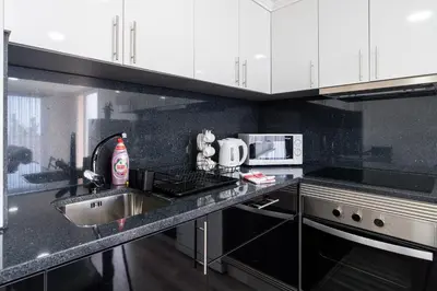 a kitchen with a sink and a counter top at Casa Terra-Boa in Arco da Calheta