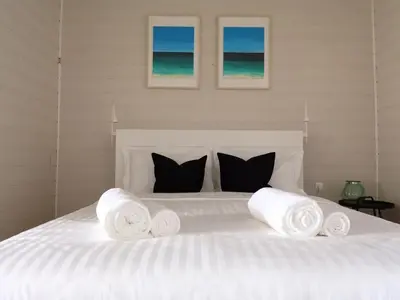 a bedroom with a white bed with towels on it at Beachfront Apartments Porto de Mós Beach - Lagos in Lagos