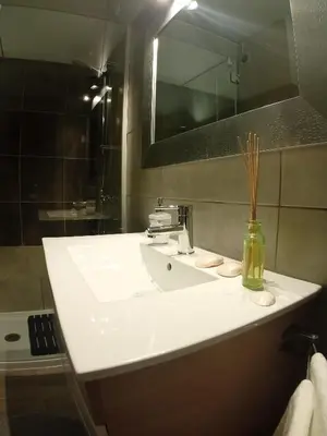 a bathroom with a white sink and a mirror at Beachfront Apartments Porto de Mós Beach - Lagos in Lagos