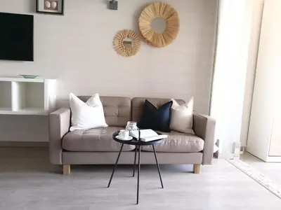 a living room with a couch and a table at Beachfront Apartments Porto de Mós Beach - Lagos in Lagos