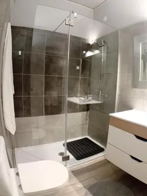 a bathroom with a shower with a toilet and a sink at Beachfront Apartments Porto de Mós Beach - Lagos in Lagos
