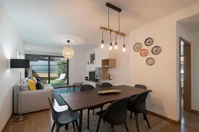 a dining room and living room with a table and chairs at Pena II by An Island Apart in Funchal