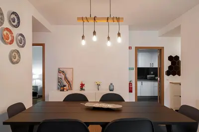 a dining room with a wooden table and chairs at Pena II by An Island Apart in Funchal