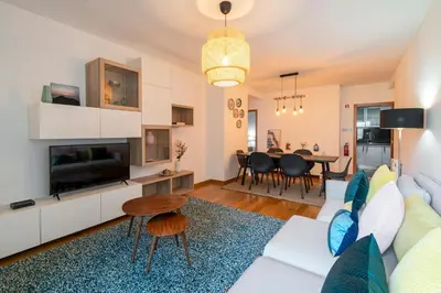 a living room with a white couch and a table at Pena II by An Island Apart in Funchal