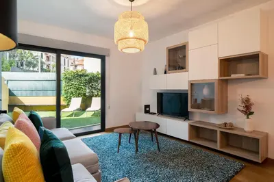 a living room with a couch and a tv at Pena II by An Island Apart in Funchal