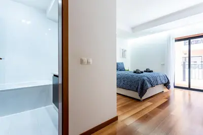 a bedroom with a bed in a white room at Rock and Sea - Baia da Luz in Luz