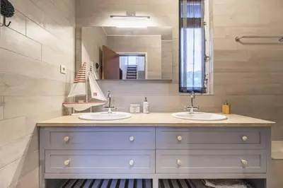 a bathroom with two sinks and a large mirror at Charming Villa, spacious, beautiful views! in Funchal