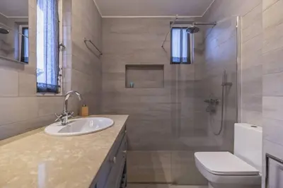 a bathroom with a sink and a shower and a toilet at Charming Villa, spacious, beautiful views! in Funchal