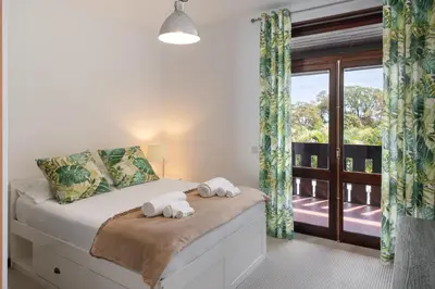 a bedroom with a bed with towels on it at Charming Villa, spacious, beautiful views! in Funchal