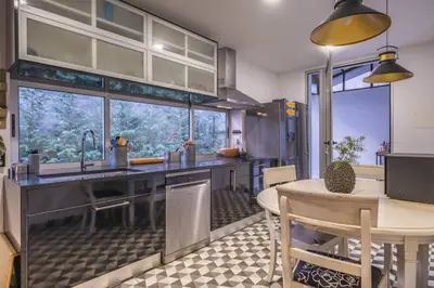 a kitchen with a table and a large window at Charming Villa, spacious, beautiful views! in Funchal