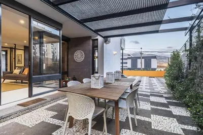 an outdoor dining room with a wooden table and chairs at Charming Villa, spacious, beautiful views! in Funchal