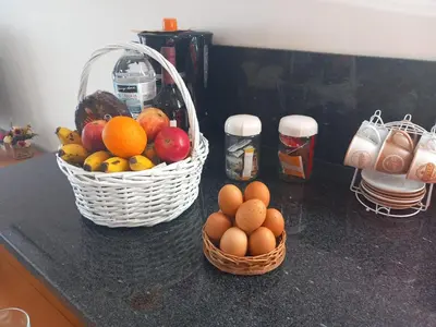 two baskets of fruit and eggs on a counter at CASA SOL E VISTA 2 in Arco da Calheta
