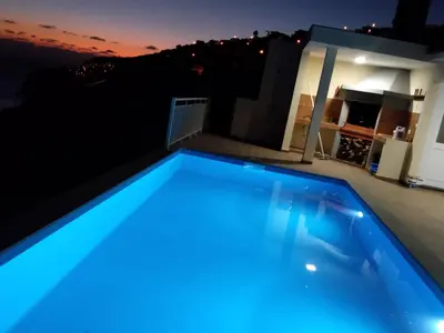 a blue swimming pool on the roof of a house at CASA SOL E VISTA 2 in Arco da Calheta