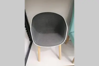 a gray chair with wooden legs next to a monitor at Vila Relax Vacation Rental, Funchal in Funchal