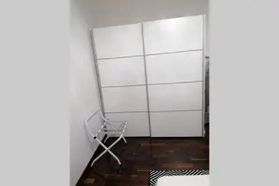 a white closet with a chair in a room at Vila Relax Vacation Rental, Funchal in Funchal