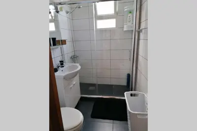 a bathroom with a toilet and a sink at Vila Relax Vacation Rental, Funchal in Funchal
