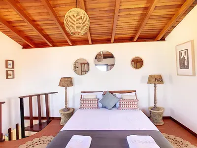 a bedroom with a bed with a wooden ceiling at Pôr do Sol by LovelyStay in Calheta