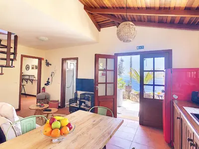 a kitchen with a table with a bowl of fruit on it at Pôr do Sol by LovelyStay in Calheta