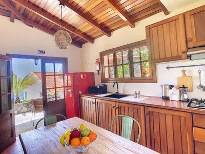a kitchen with a table with a bowl of fruit on it at Pôr do Sol by LovelyStay in Calheta