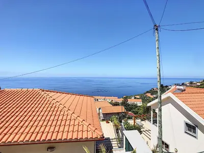 a view of the ocean from the roofs of buildings at Pôr do Sol by LovelyStay in Calheta