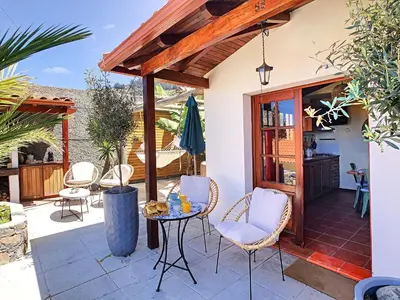 a patio with a table and chairs on a patio at Pôr do Sol by LovelyStay in Calheta