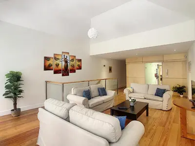 a living room with white couches and a table at Casa Conceição by LovelyStay in Funchal