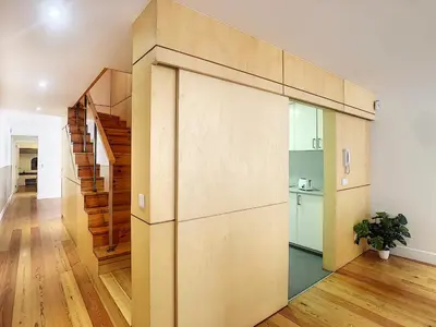 a large pivot door in a room with a kitchen at Casa Conceição by LovelyStay in Funchal