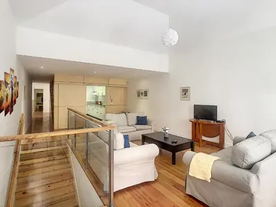 a living room with two couches and a television at Casa Conceição by LovelyStay in Funchal