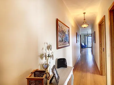a hallway with white walls and a table and chairs at Gemini Apartment by LovelyStay in Funchal
