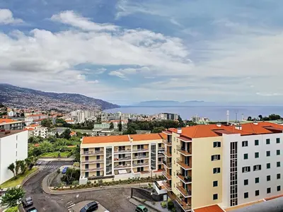 an aerial view of a city with buildings and the ocean at Gemini Apartment by LovelyStay in Funchal