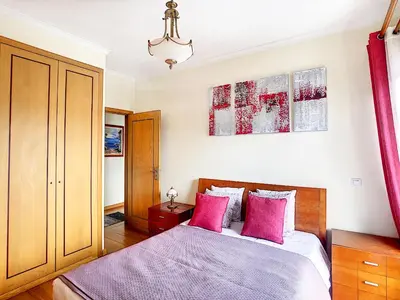 a bedroom with a bed with pink pillows at Gemini Apartment by LovelyStay in Funchal