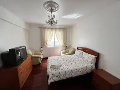 a small bedroom with a bed and a tv at Comfortable 2-Bedroom Apartment for Relaxing Stays in Funchal