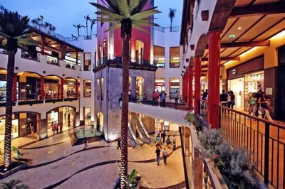 a shopping mall with a palm tree in the middle at Comfortable 2-Bedroom Apartment for Relaxing Stays in Funchal
