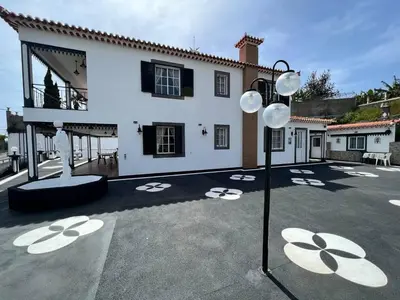 a white house with a courtyard with a street light at Comfortable 2-Bedroom Apartment for Relaxing Stays in Funchal
