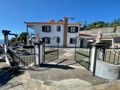 a gate in front of a house at Comfortable 2-Bedroom Apartment for Relaxing Stays in Funchal