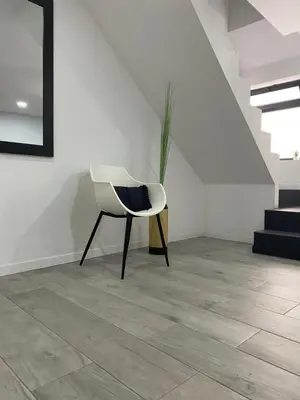 a white chair and a plant in a room at Zoe House in Paul do Mar