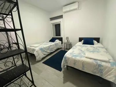 a bedroom with two beds and a ladder in it at Zoe House in Paul do Mar