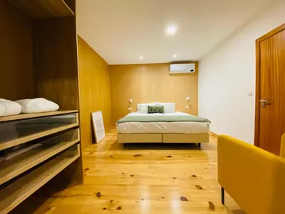 a bedroom with a bed and a dresser at Villas Calhau da Lapa 51 in Campanário