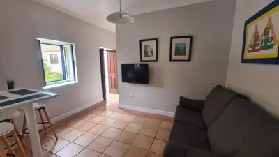 a living room with a couch and a table at Casa da Avó Duca in Machico