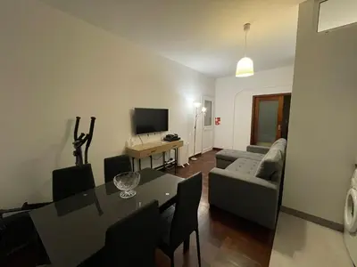 a living room with a table and a couch at Shining in Funchal