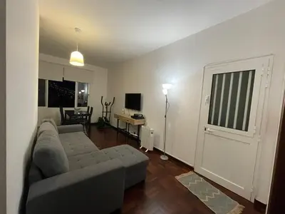 a living room with a couch and a table and a door at Shining in Funchal