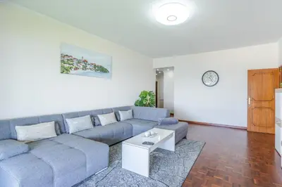 a living room with a couch and a table at Flowers island house 3 in Caniço