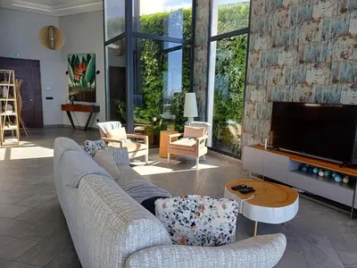 a living room with a couch and a flat screen tv at Villa Estrelícia by LovelyStay in Ribeira Brava
