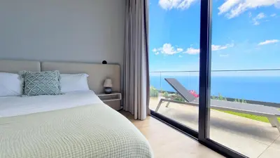 a bedroom with a bed and a view of the ocean at Villa Estrelícia by LovelyStay in Ribeira Brava