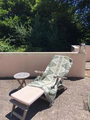 a bench with a blanket and a stool on a patio at Quintinha de Palmyra in Camacha