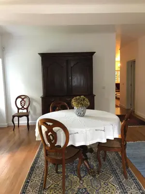 a dining room table with a vase of flowers on it at Quintinha de Palmyra in Camacha